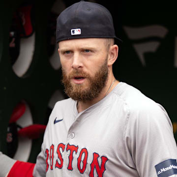 Apr 3, 2024; Oakland, California, USA; Boston Red Sox shortstop Trevor Story (10) arranges his gear in the dugout before taking on the Oakland Athletics at Oakland-Alameda County Coliseum.