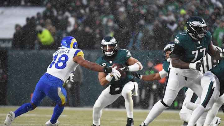 Jan 19, 2025; Philadelphia, Pennsylvania, USA; Philadelphia Eagles quarterback Jalen Hurts vs Los Angeles Rams linebacker Omar Speights. Mandatory Credit: Eric Hartline-Imagn Images
