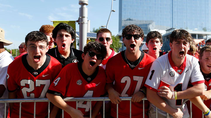 Georgia fans bark as Georgia arrives before the start of the NCAA Aflac Kickoff Game in Atlanta, on Saturday, Aug. 31, 2024.