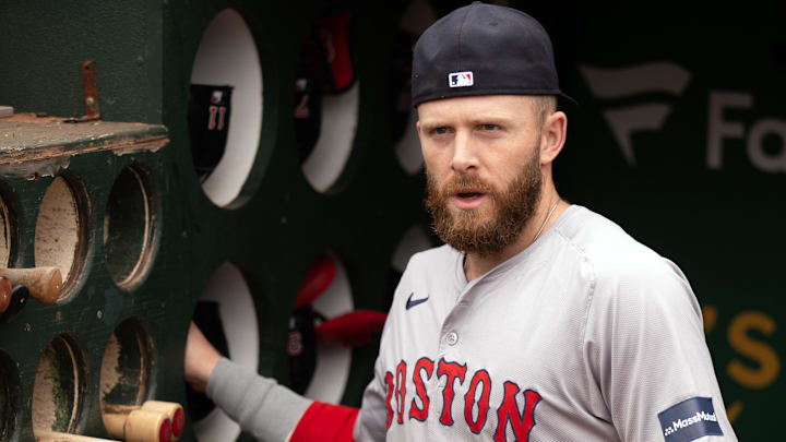 Apr 3, 2024; Oakland, California, USA; Boston Red Sox shortstop Trevor Story (10) arranges his gear in the dugout before taking on the Oakland Athletics at Oakland-Alameda County Coliseum.