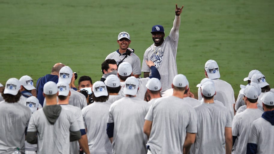 Randy Arozarena (back, raising hand) celebrates an American League pennant with his teammates.