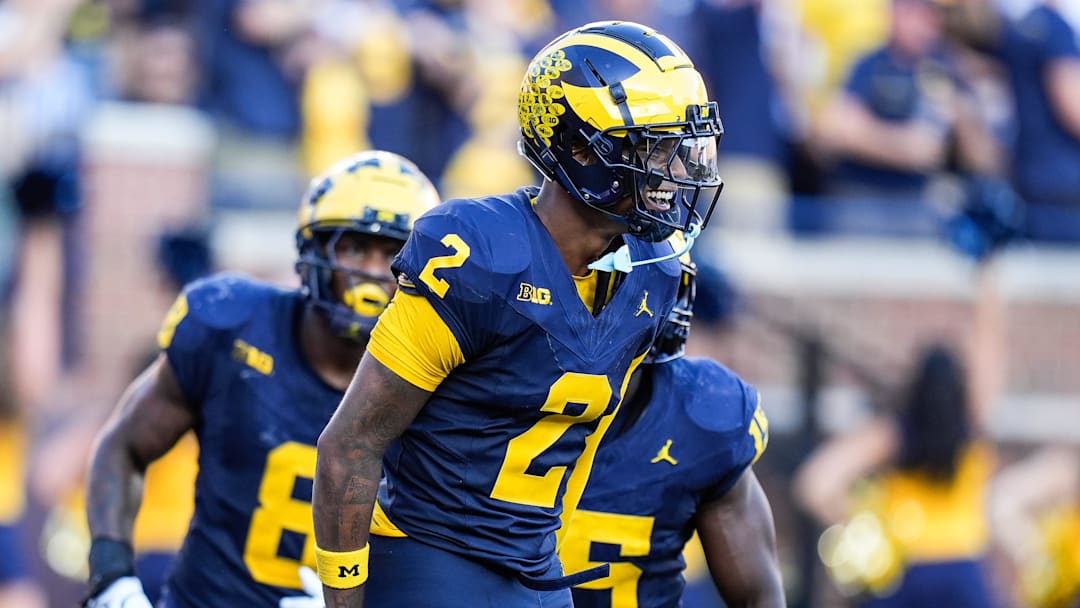 Michigan defensive back Will Johnson (2) celebrates a touchdown after intercepting USC quarterback Miller Moss (7) during the second half at Michigan Stadium in Ann Arbor on Saturday, Sept. 21, 2024.