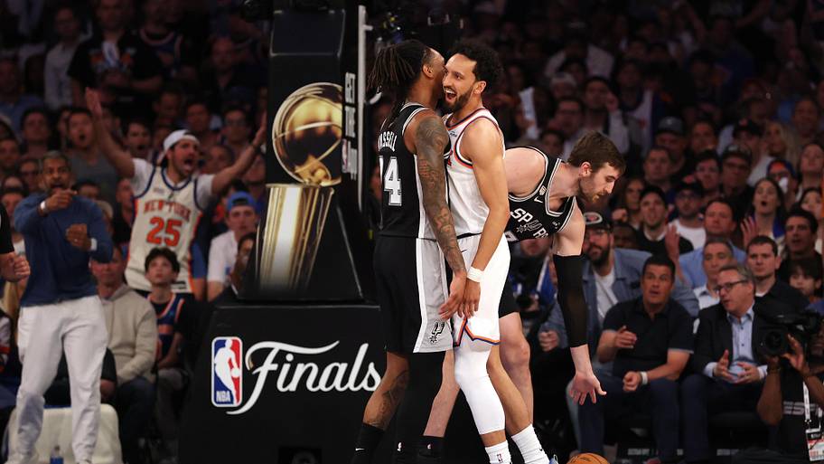 San Antonio Spurs guard Devin Vassell and New York Knicks guard Landry Shamet bump each other after a play in the NBA Finals.