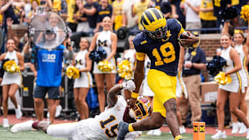 Michigan quarterback Bryce Underwood (19) runs for a touchdown against Central Michigan defensive back Caleb Spann (15) during the first half at Michigan Stadium in Ann Arbor on Saturday, Sept. 13, 2025.