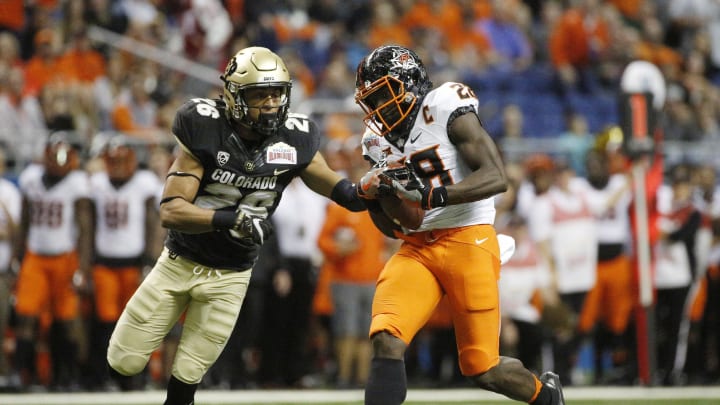 Dec 29, 2016; San Antonio, TX, USA; Oklahoma State Cowboys wide receiver James Washington (28) catches a pass while being defended by Colorado Buffaloes defensive back Isaiah Oliver (26, left) during the first half at Alamodome. Mandatory Credit: Soobum Im-USA TODAY Sports