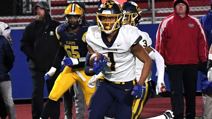 Micah Rice heads upfield with an interception for Moeller in the OHSAA Division I football state semifinals at Piqua, Ohio, Nov. 24, 2023.