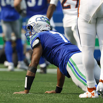 Sep 8, 2024; Seattle, Washington, USA; Seattle Seahawks quarterback Geno Smith (7) reacts after throwing an interception against the Denver Broncos during the first quarter at Lumen Field. Mandatory Credit: Joe Nicholson-Imagn Images