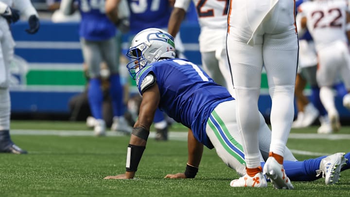 Sep 8, 2024; Seattle, Washington, USA; Seattle Seahawks quarterback Geno Smith (7) reacts after throwing an interception against the Denver Broncos during the first quarter at Lumen Field. Mandatory Credit: Joe Nicholson-Imagn Images