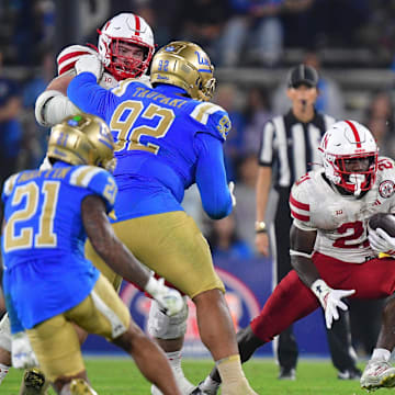 Nov 8, 2025; Pasadena, California, USA; Nebraska Cornhuskers running back Emmett Johnson (21) runs the ball against the UCLA Bruins during the second half at the Rose Bowl. Mandatory Credit: Gary A. Vasquez-Imagn Images