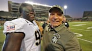 Army Black Knights head coach Jeff Monken celebrates a win with defensive lineman Dre Miller.