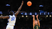Mar 21, 2025; Seattle, WA, USA; Colorado State Rams guard Kyan Evans (0) shoots over Memphis Tigers center Moussa Cisse (32) during the first half at Climate Pledge Arena. Mandatory Credit: Steven Bisig-Imagn Images