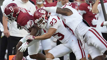 Oklahoma defensive back Eli Bowen tackles Alabama wide receiver Lotzeir Brooks.