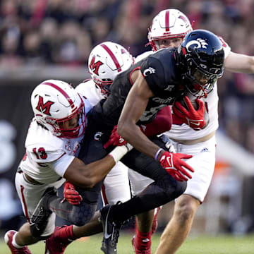 Sept. 16, 2023; Cincinnati, OH; Cincinnati Bearcats wide receiver Xzavier Henderson (8) runs with the ball as three Miami (Oh) RedHawks pursue during the NCAA football game between the Cincinnati Bearcats and the Miami RedHawks at Nippert Stadium. Mandatory Credit: Carter Skaggs-USA TODAY NETWORK