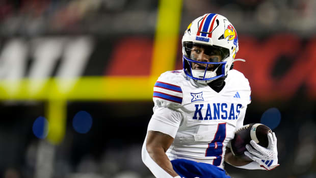 Kansas Jayhawks running back Devin Neal (4) scores a touch down during the NCAA college football game between the Cincinnati 