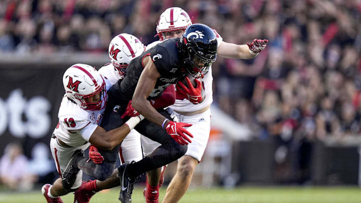 Sept. 16, 2023; Cincinnati, OH; Cincinnati Bearcats wide receiver Xzavier Henderson (8) runs with the ball as three Miami (Oh) RedHawks pursue during the NCAA football game between the Cincinnati Bearcats and the Miami RedHawks at Nippert Stadium. Mandatory Credit: Carter Skaggs-USA TODAY NETWORK