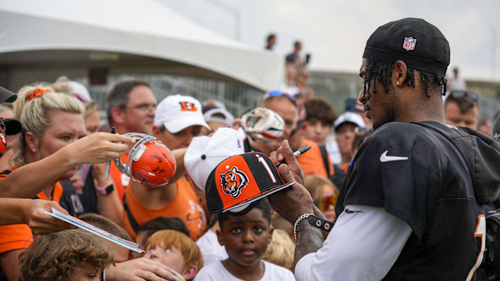 Cincinnati Bengals wide receiver Ja'Marr Chase (1) signs a fanâ€™s hat after a joint practice between the Green Bay Packers and the Cincinnati Bengals, Wednesday, Aug. 9, 2023, at the practice fields next to Paycor Stadium in Cincinnati.