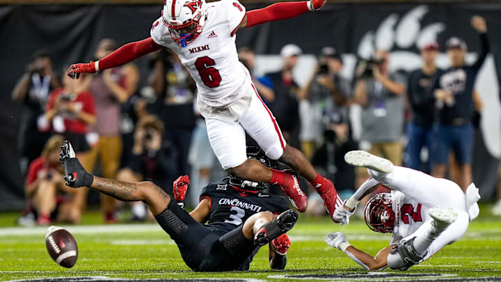 Miami (Oh) RedHawks defensive back Jacquez Warren (6) jumps over Cincinnati Bearcats wide receiver Evan Prater (3) during the NCAA football game between the Cincinnati Bearcats and the Miami RedHawks at Nippert Stadium in Cincinnati on Saturday, Sept. 16, 2023.