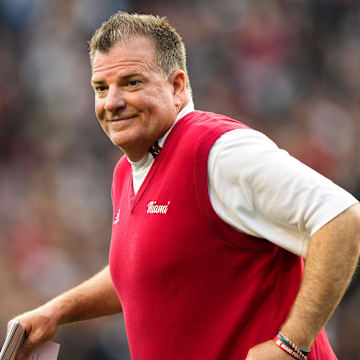 Miami (Oh) Redhawks head coach Chuck Martin runs onto the field 