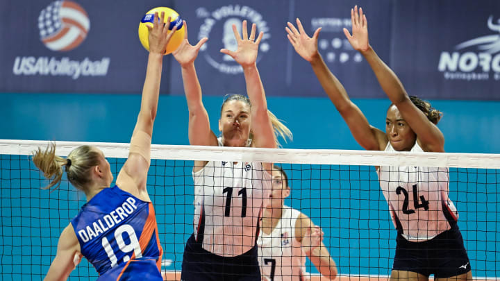 Netherlands outside hitter Nika Daalderop (19) tries to spike over USA blocks Annie Drews (11) and Chiaka Ogbogu (24) 