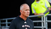 Aug 28, 2025; Raleigh, North Carolina, USA; North Carolina State Wolfpack head coach Dave Doeren walks out during the warmups prior to the game against East Carolina Pirates at Carter-Finley Stadium. Mandatory Credit: Jaylynn Nash-Imagn Images