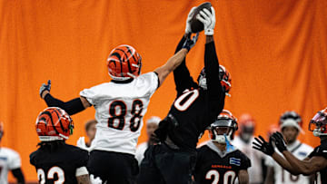 Cincinnati Bengals linebacker Shaka Heyward (50) intercepts a pass intended for Cincinnati Bengals tight end Mike Gesicki (88) at Bengals spring practice at the IEL Indoor Facility in Cincinnati on Wednesday, June 12, 2024.