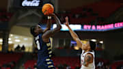 Dec 16, 2024; Lubbock, Texas, USA;  Oral Roberts Golden Eagles guard JoJo Moore (0) takes a shot over Texas Tech Red Raiders guard Chance McMillian (0) in the second half at United Supermarkets Arena. 