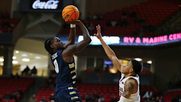 Dec 16, 2024; Lubbock, Texas, USA;  Oral Roberts Golden Eagles guard JoJo Moore (0) takes a shot over Texas Tech Red Raiders guard Chance McMillian (0) in the second half at United Supermarkets Arena. 