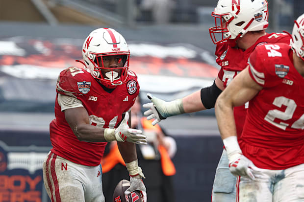 Nebraska running back Emmett Johnson celebrates with teammates after scoring a touchdown in the 2024 Pinstripe Bowl
