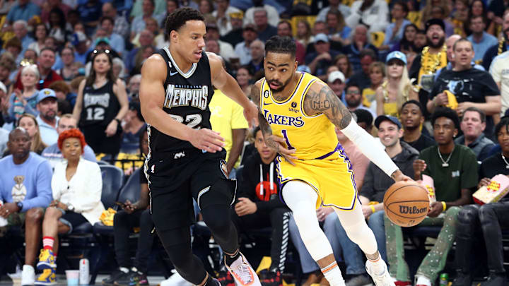 Apr 19, 2023; Memphis, Tennessee, USA; Los Angeles Lakers guard D'Angelo Russell (1) drives to the basket as Memphis Grizzlies guard Desmond Bane (22) defends during the first half of game two of the 2023 NBA playoffs at FedExForum. Mandatory Credit: Petre Thomas-Imagn Images