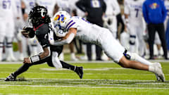 Kansas defensive end Austin Booker moves in for the tackle against Cincinnati. 