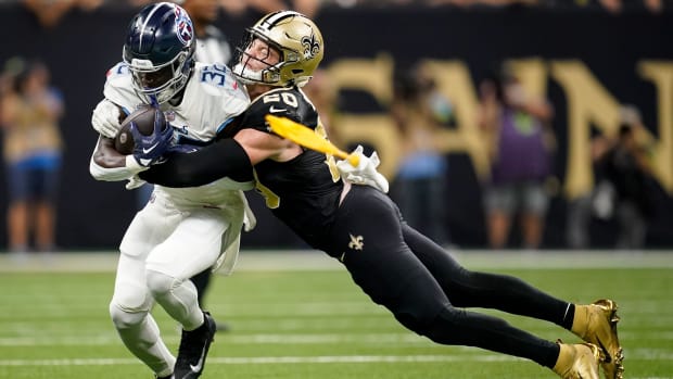 Tennessee Titans running back Tyjae Spears (32) is tackled by New Orleans Saints linebacker Pete Werner (20) 