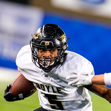 Boyle County (Kentucky) all-purpose player Montavin Quisenberry, left, did it all Saturday in a win over St. Edward (Ohio).