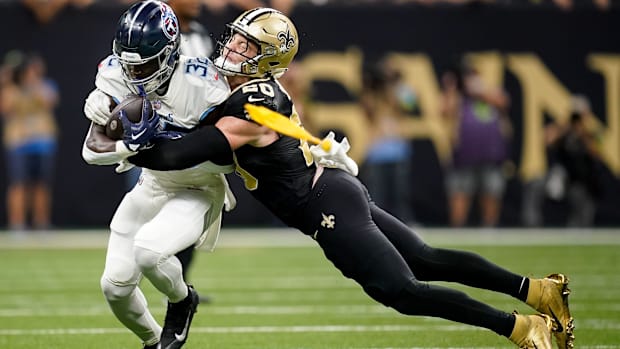 Tennessee Titans running back Tyjae Spears (32) is tackled by New Orleans Saints linebacker Pete Werner (20) 