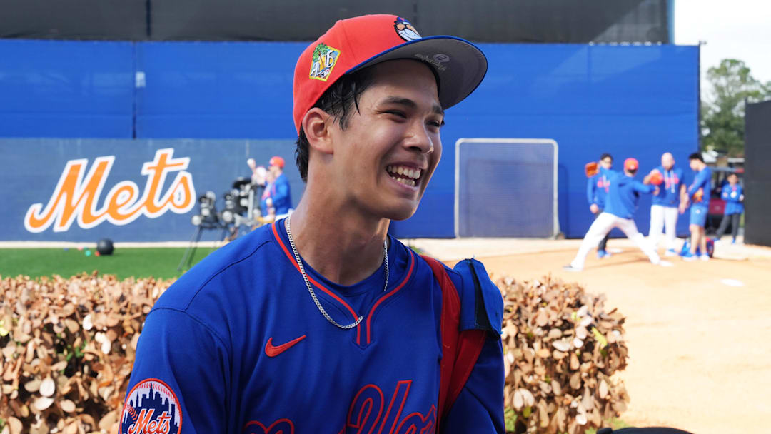 Feb 16, 2026; Port St. Lucie, FL, USA;  New York Mets pitcher Jonah Tong (21) smiles as he takes a picture with fans during spring training at Clover Park. Mandatory Credit: Jim Rassol-Imagn Images