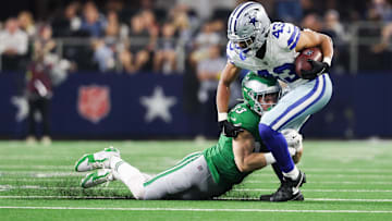Nov 23, 2025; Arlington, Texas, USA;  Dallas Cowboys running back Malik Davis (43) is brought down by Philadelphia Eagles cornerback Cooper Dejean (33) in the third quarter at AT&T Stadium.