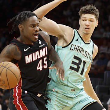 Mar 23, 2025; Miami, Florida, USA;  Charlotte Hornets forward Tidjane Salaun (31) defends Miami Heat guard Davion Mitchell (45) during the second half at Kaseya Center. Mandatory Credit: Rhona Wise-Imagn Images