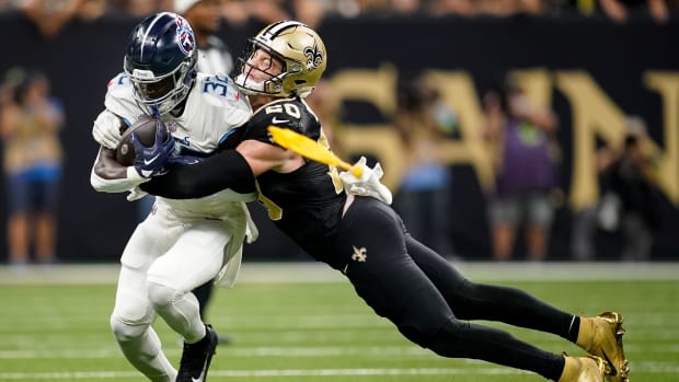 Tennessee Titans running back Tyjae Spears (32) is tackled by New Orleans Saints linebacker Pete Werner (20) 