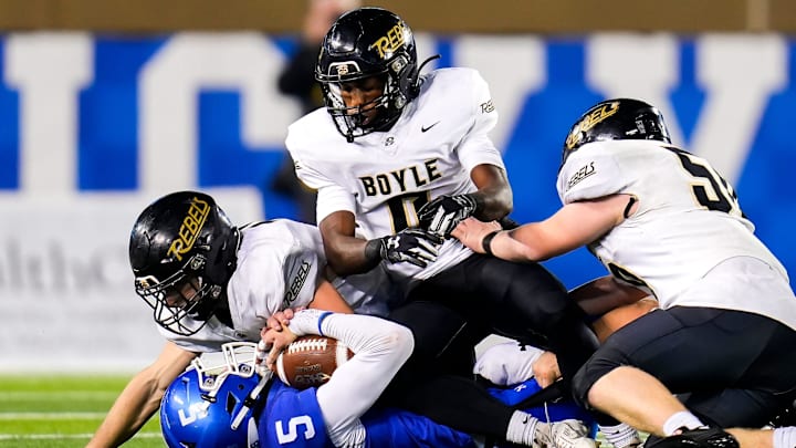 Covington Catholic Colonels quarterback is tackled to the ground by three Boyle County Rebels Covington Catholic Colonels quarterback is tackled to the ground by three Boyle County Rebels
