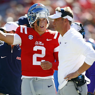 Sep 7, 2024; Oxford, Mississippi, USA; Mississippi Rebels quarterback Jaxson Dart (2) talks with head coach Lane Kiffin on the sideline during the first half against the Middle Tennessee Blue Raiders at Vaught-Hemingway Stadium. Mandatory Credit: Petre Thomas-Imagn Images