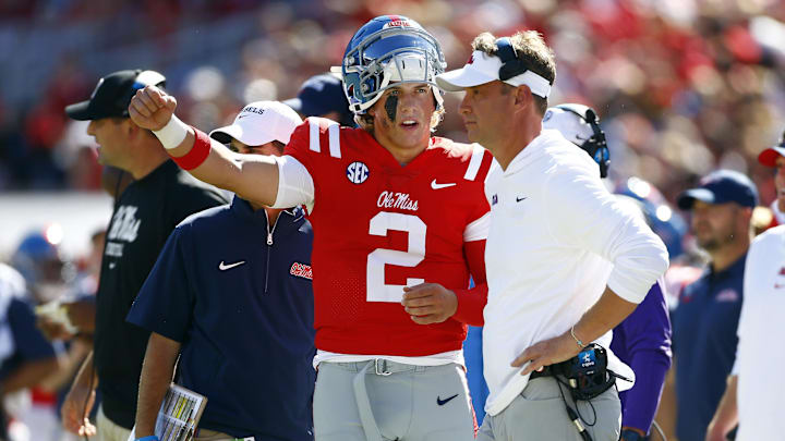 Sep 7, 2024; Oxford, Mississippi, USA; Mississippi Rebels quarterback Jaxson Dart (2) talks with head coach Lane Kiffin on the sideline during the first half against the Middle Tennessee Blue Raiders at Vaught-Hemingway Stadium. Mandatory Credit: Petre Thomas-Imagn Images