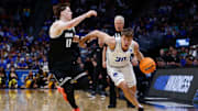 Mar 20, 2025; Denver, CO, USA; Brigham Young Cougars guard Dallin Hall (30) dribbles the ball against VCU Rams guard Max Shulga (11) during the second half in the first round of the NCAA Tournament at Ball Arena. Mandatory Credit: Isaiah J. Downing-Imagn Images
