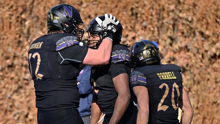 Nov 22, 2025; Chicago, Illinois, USA; Northwestern Wildcats running back Caleb Komolafe (5) celebrates his touchdown with offensive lineman Caleb Tiernan (72) and wide receiver Chase Farrell (20) against the Minnesota Golden Gophers during the first half at Wrigley Field. Mandatory Credit: Patrick Gorski-Imagn Images