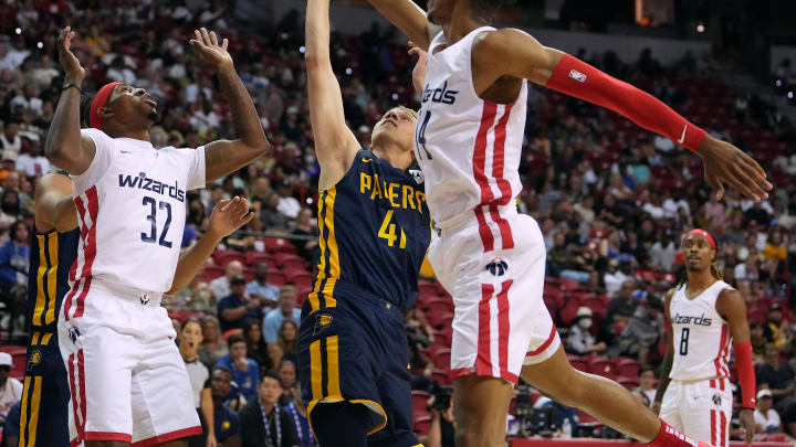 Jul 15, 2022; Las Vegas, NV, USA; Indiana Pacers forward David DiLeo (41) shoots between Washington Wizards guard Craig Sword (32) and Washington Wizards guard Isaiah Todd (14) during an NBA Summer League game at Thomas & Mack Center. Mandatory Credit: Stephen R. Sylvanie-USA TODAY Sports