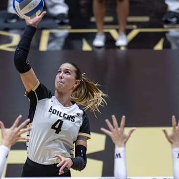 Purdue Junior Kenna Wollard (4) floats the ball over blockers 