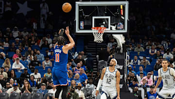 Dec 15, 2024; Orlando, Florida, USA; New York Knicks guard Jalen Brunson (11) shoots the ball over Orlando Magic guard Trevelin Queen (12) in the fourth quarter at Kia Center. Mandatory Credit: Jeremy Reper-Imagn Images