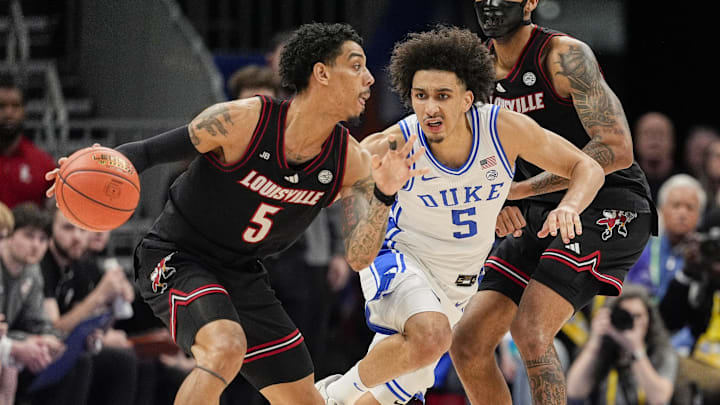 Louisville Cardinals guard Terrence Edwards Jr. (5) handles the ball defended by Duke Blue Devils guard Tyrese Proctor