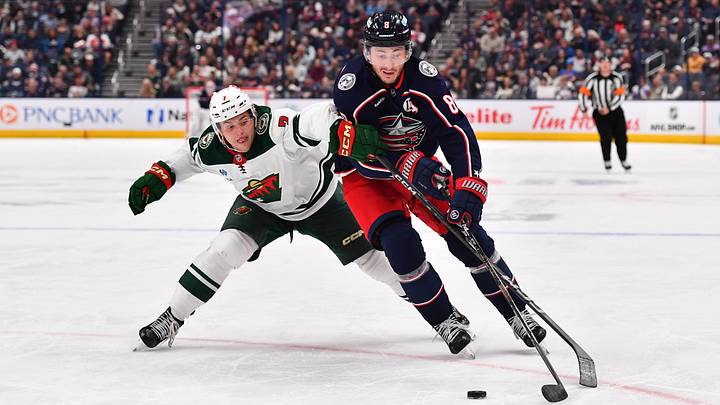 Blue Jackets defenseman Zach Werenski works against Minnesota Wild's Brock Faber. 
