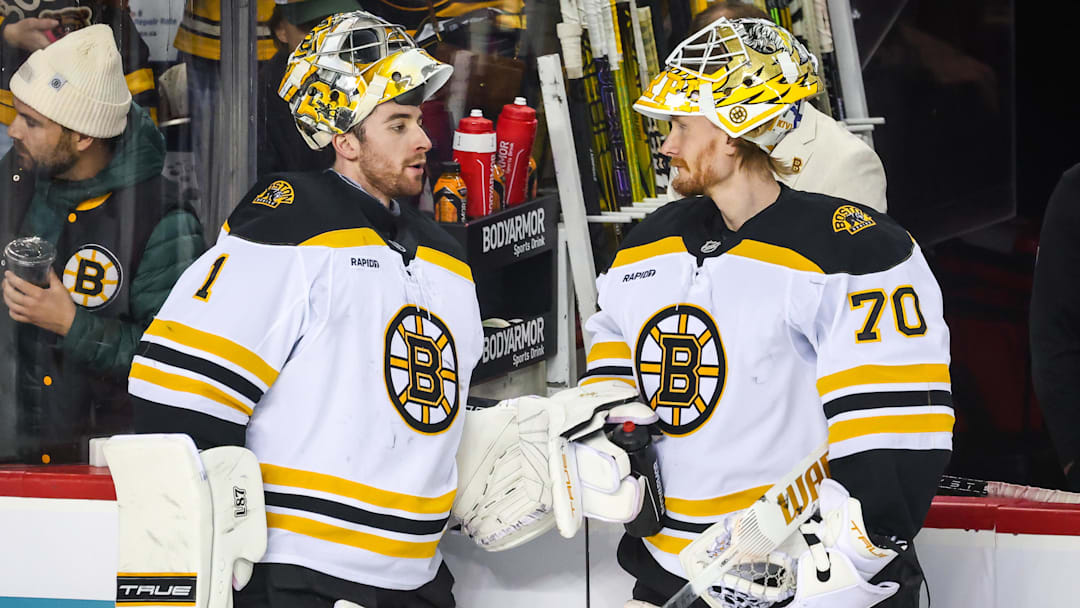 Dec 17, 2024; Calgary, Alberta, CAN; Boston Bruins goaltender Jeremy Swayman (1) and goaltender Joonas Korpisalo (70) during the warmup period against the Calgary Flames at Scotiabank Saddledome. Mandatory Credit: Sergei Belski-Imagn Images merp
