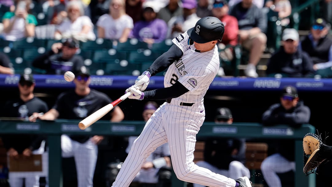 Apr 23, 2026; Denver, Colorado, USA; Colorado Rockies left fielder Mickey Moniak (22) hits a solo home run in the first inning against the San Diego Padres at Coors Field. Mandatory Credit: Isaiah J. Downing-Imagn Images