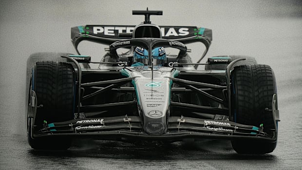 A close-up of Mercedes driver George Russell maneuvering his car around the track at Albert Park Grand Prix Circuit.